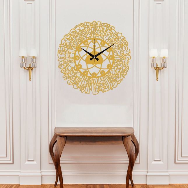 Decorative wall clock with intricate design on a white wall above a wooden console table.