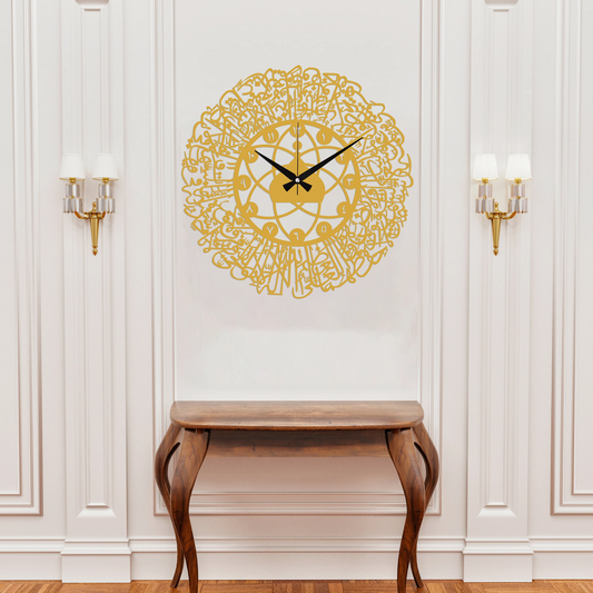 Decorative wall clock with intricate design on a white wall above a wooden console table.